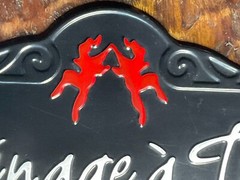 Ménage à Trois Black Metal Barware Sign with Playful Red Twin Dancers Logo