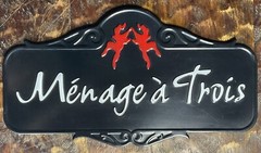 Ménage à Trois Black Metal Barware Sign with Playful Red Twin Dancers Logo